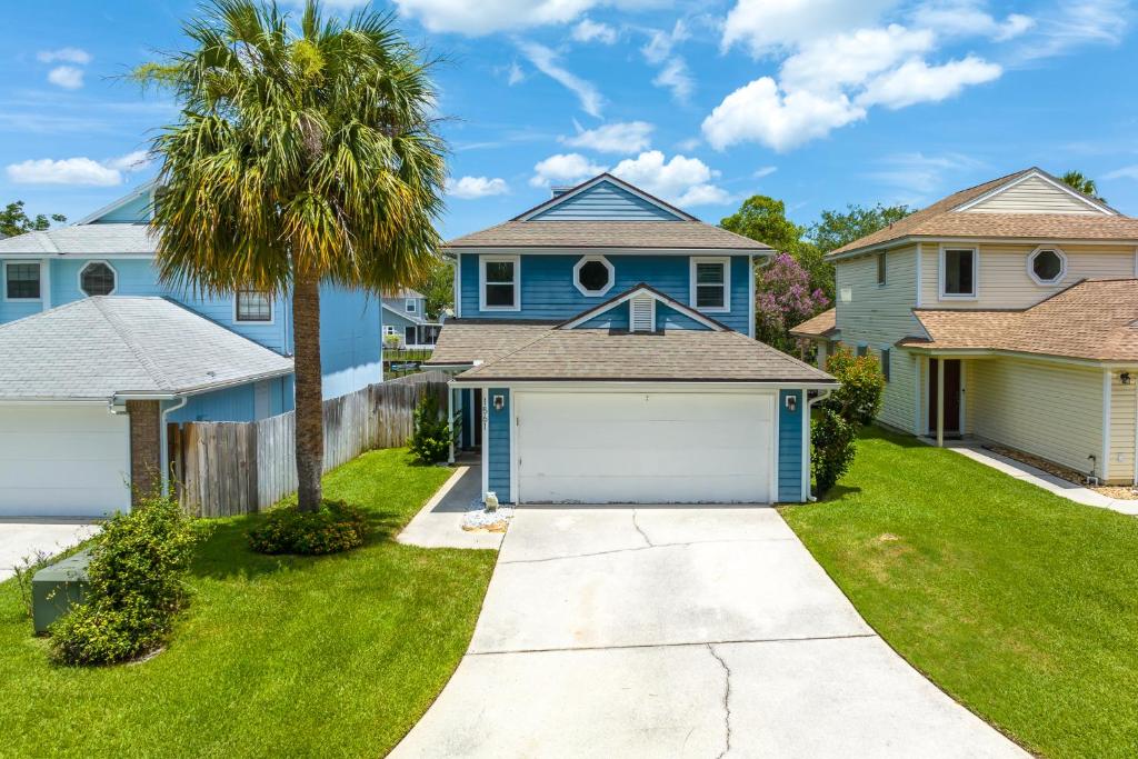 a house with a palm tree and a garage at Paradise Palm in Jacksonville Beach