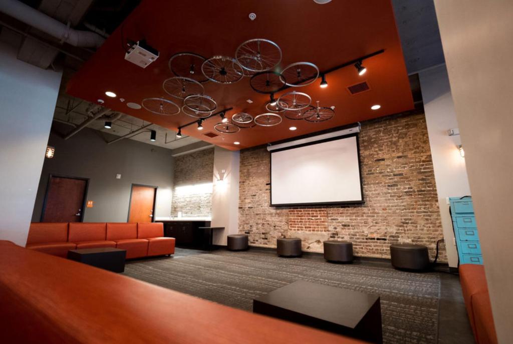 a waiting room with a projection screen in a building at Sleepover Luxe Downtown Springfield Apartments in Springfield