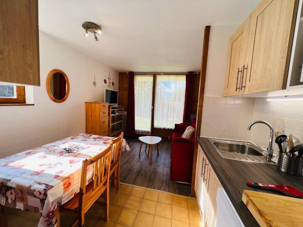 a kitchen with a table and a sink in a room at Appartement Les Saisies, 2 pièces, 5 personnes - FR-1-293-196 in Les Saisies
