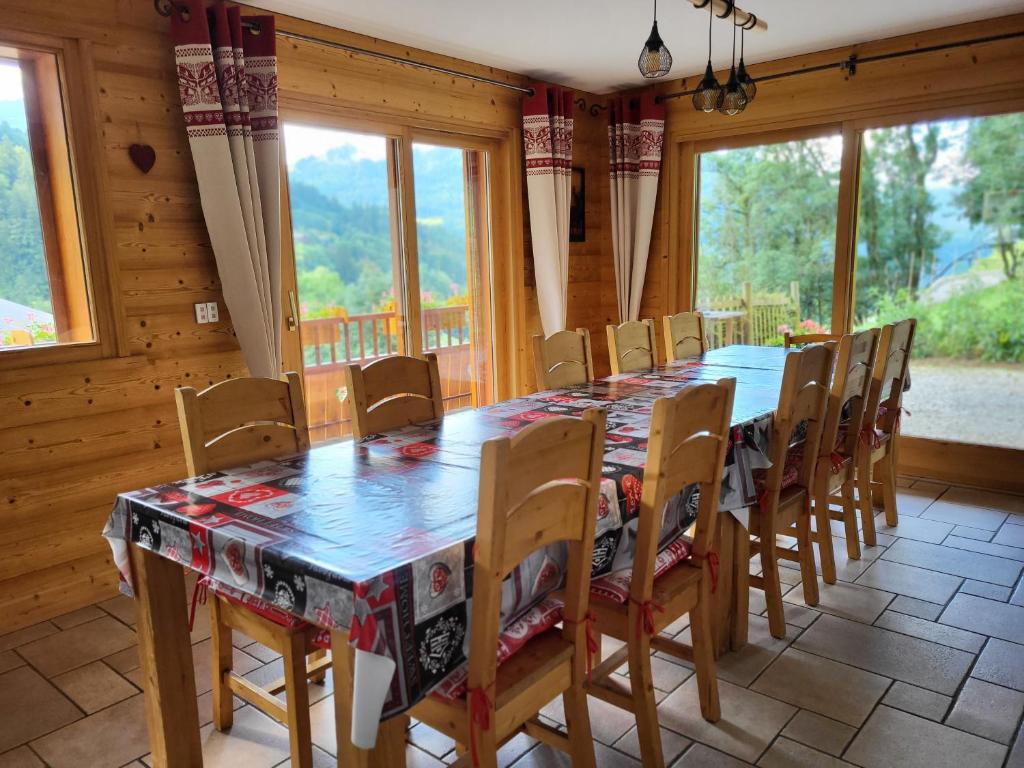 a dining room with a long table and chairs at La petite Anfiane in Le Grand-Bornand