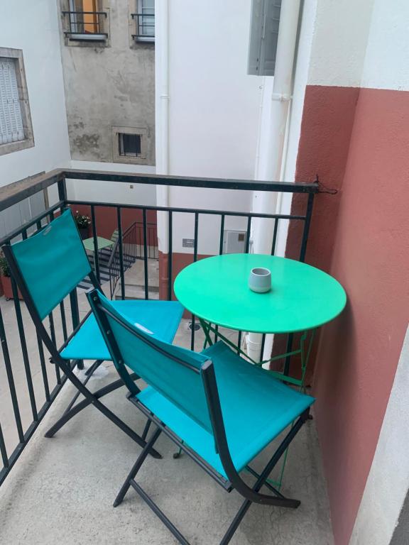 a table and two chairs on a balcony at Studio B hyper centre in Lons-le-Saunier