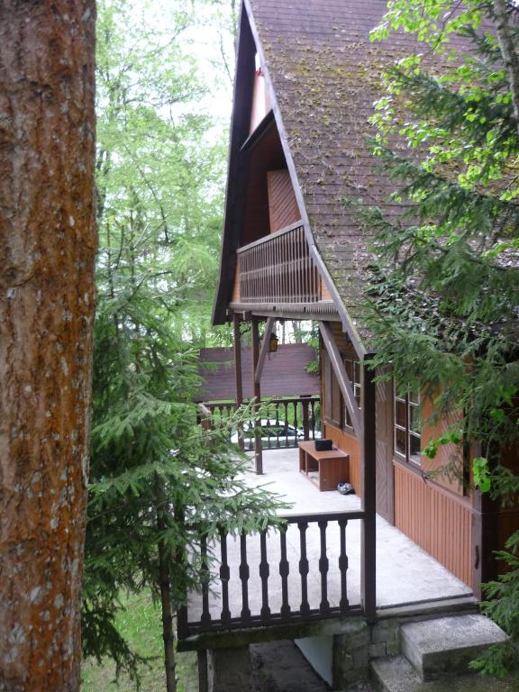 a large house with a porch and a balcony at Dowcień in Burdeniszki