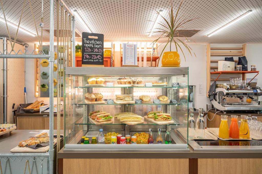 a bakery with a display case filled with food at UCPA SPORT STATION HOSTEL PARIS in Paris