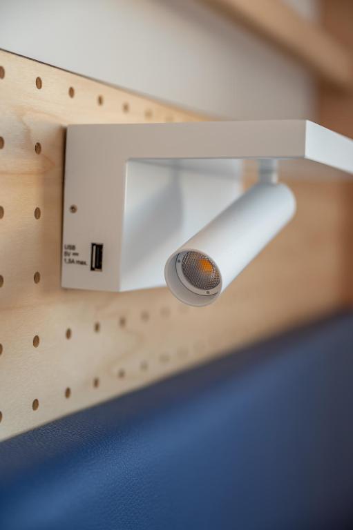 a light on a wooden wall with a light switch at UCPA SPORT STATION HOSTEL PARIS in Paris