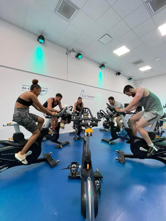 a group of people riding on bikes in a gym at UCPA SPORT STATION HOSTEL PARIS in Paris