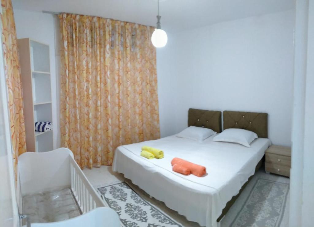 a bedroom with a bed with two stuffed animals on it at Dar Lilia Monastir in Monastir