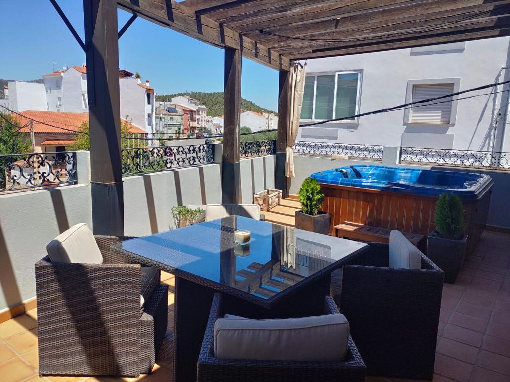 a patio with a table and chairs and a hot tub at vivienda rural AZALEA in Cortijos Nuevos