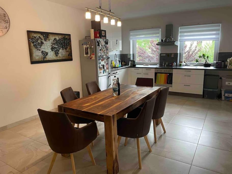 a kitchen with a wooden table and chairs at Moderne Wohnung mit Stil in Grossgerungs