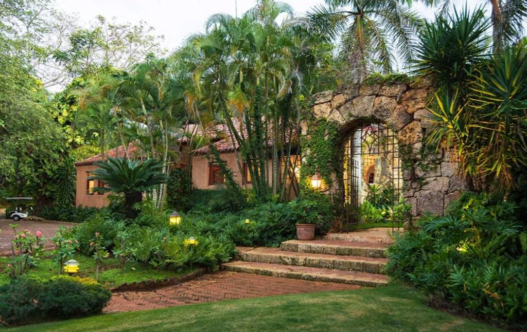 a house with a stone archway and a garden at Sunny Vacation Villa No 64 in San Rafael del Yuma