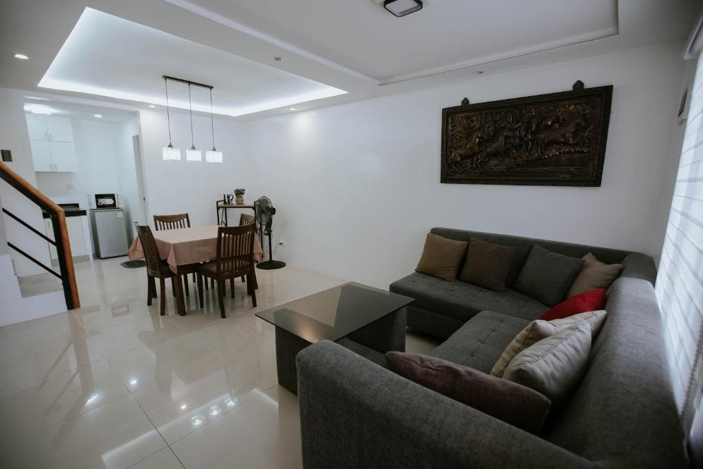 a living room with a couch and a table at Joanna's Place in Naga