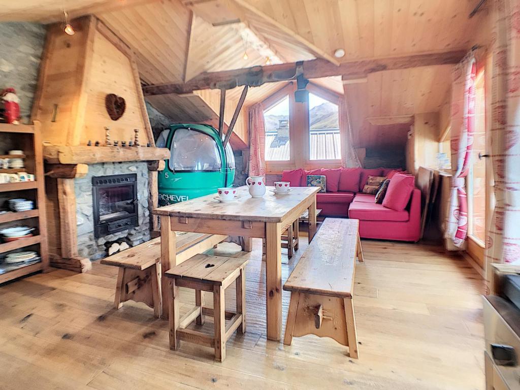 a living room with a wooden table and a couch at Chalet Saint-Martin-de-Belleville, 5 pièces, 8 personnes - FR-1-344-791 in Saint-Marcel