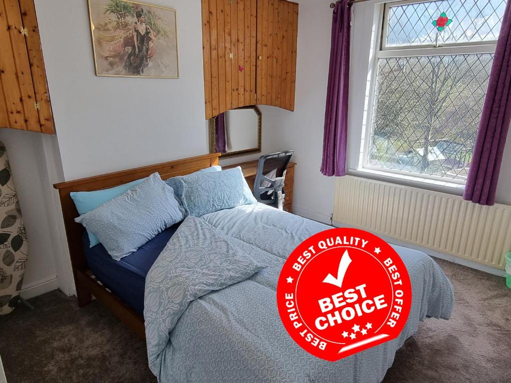 a bedroom with a bed with a best choice sign on it at 4 Bedroom House in Central Rochdale cul-de-sac Free Parking & Fast Wi-Fi in Rochdale