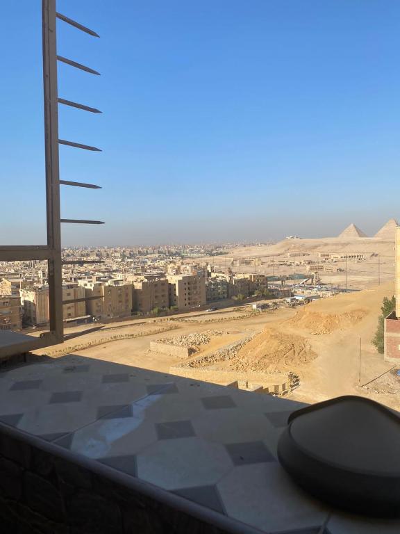 a view of a city from a building in the desert at حدائق الاهرام in ‘Ezbet `Abd el-Ḥamîd