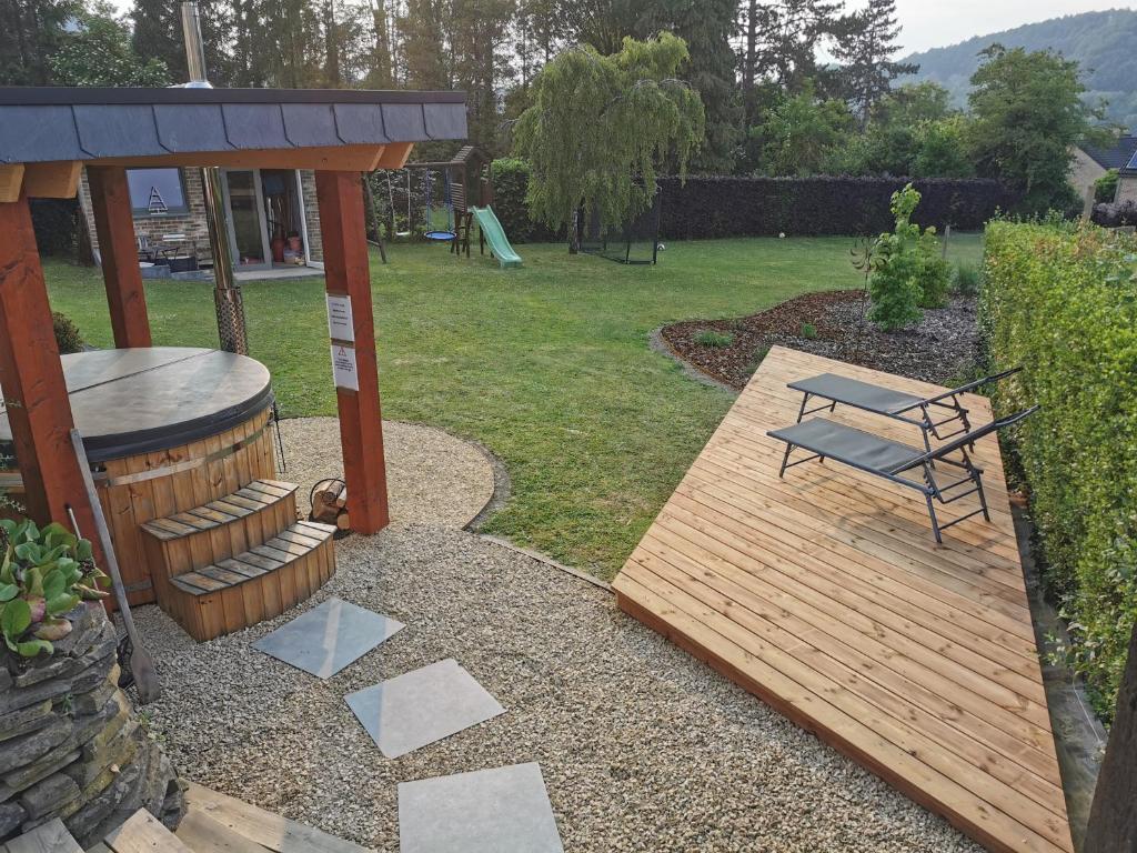 a bench and a gazebo in a yard at K-Jol et Vous in Aywaille