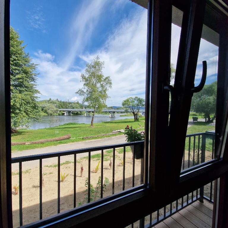 a view of a river from a window at Przystań nad Sanem in Tyrawa Solna