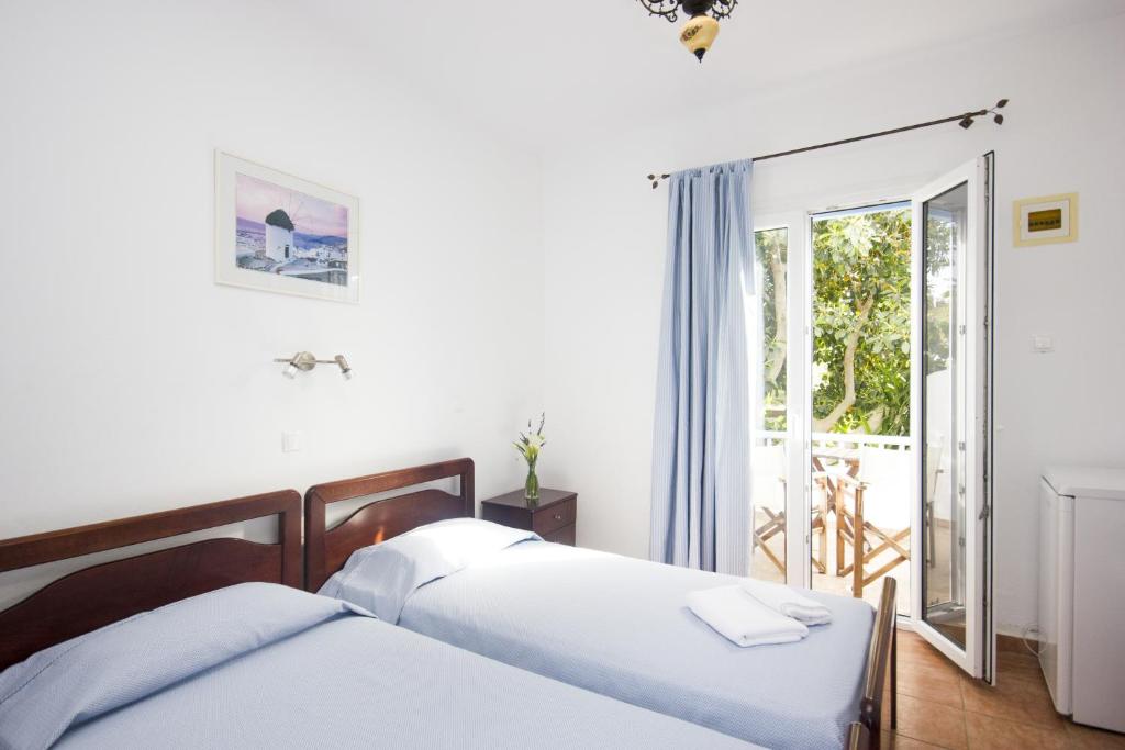 Postel nebo postele na pokoji v ubytování Sourmeli Garden Hotel