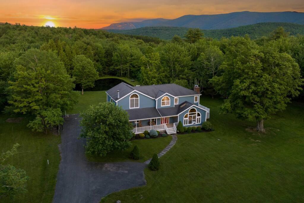 an aerial view of a house in the mountains at Mountain Blue Vista - Luxury retreat near Ski resorts with Pond, Firepit and Hot Tub in Windham