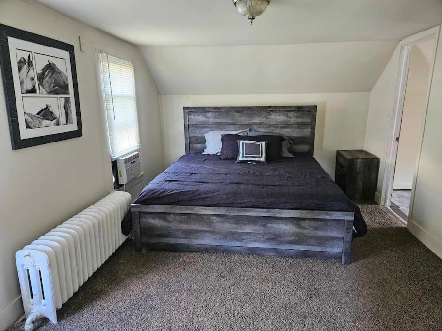 a bedroom with a bed with a laptop on it at Saratoga Track Concert Season Moonfish Cabana weekly rentals in Saratoga Springs