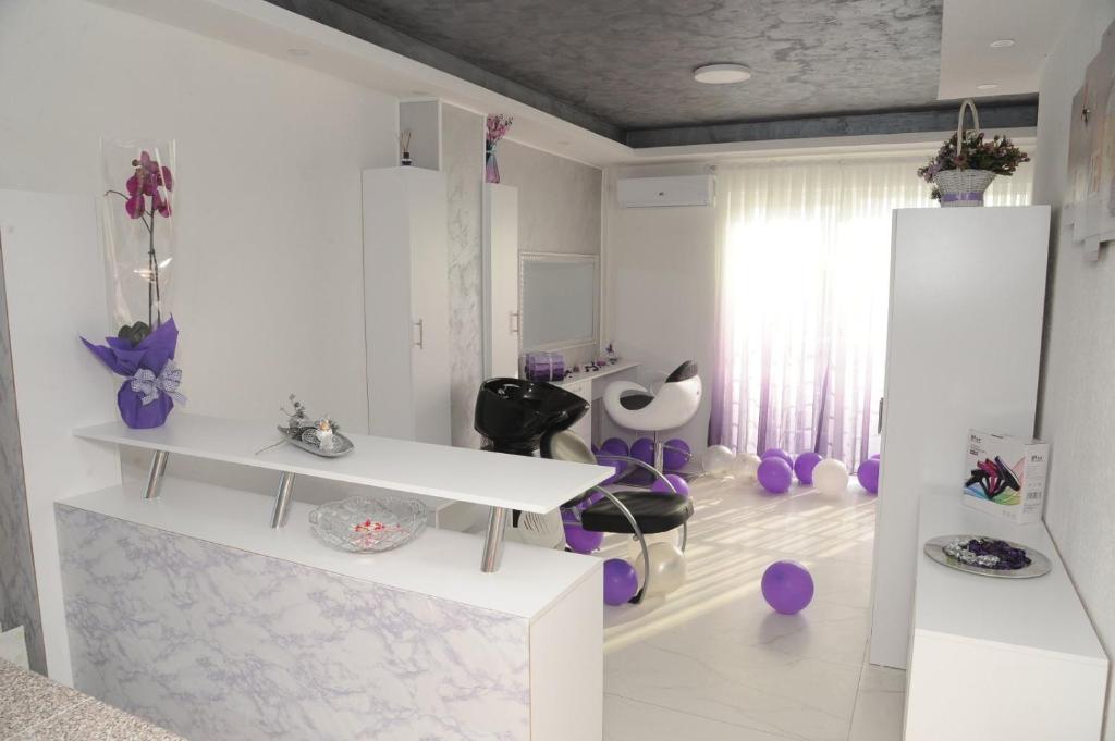 a white room with a sink and purple chairs at IN LUX Apartment Skopje 