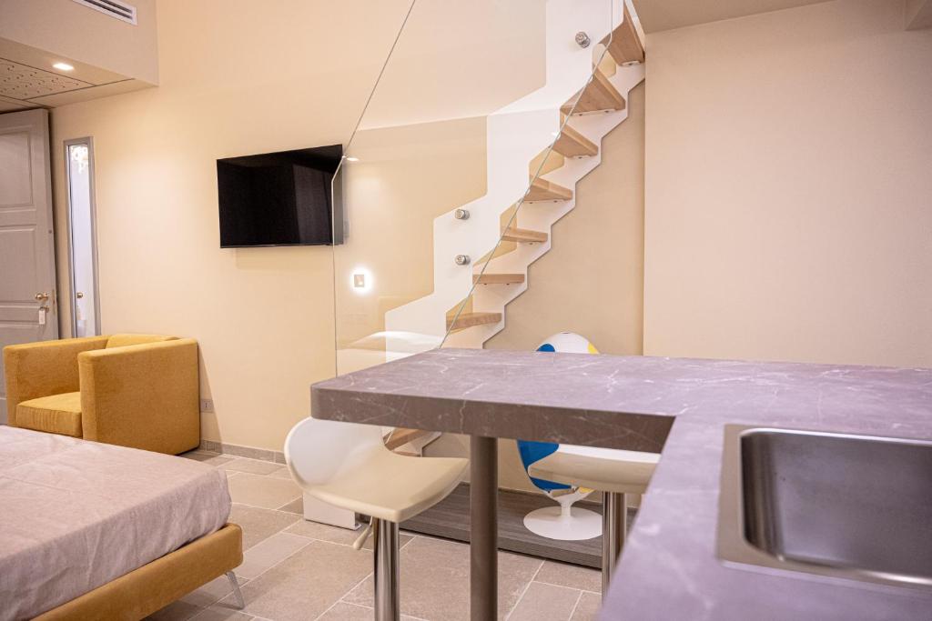 a room with a table and a staircase at Iris apartments in Monopoli