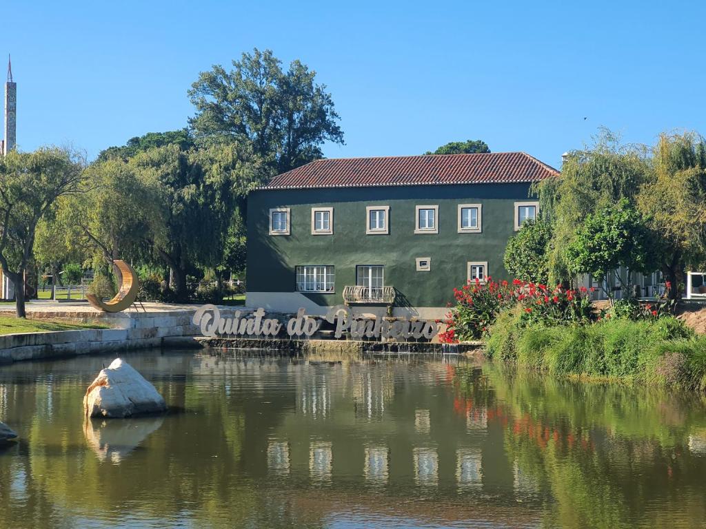 a building sitting on the side of a river at Quinta do Pinheiro Hotel Rural - GQL in Valado dos Frades