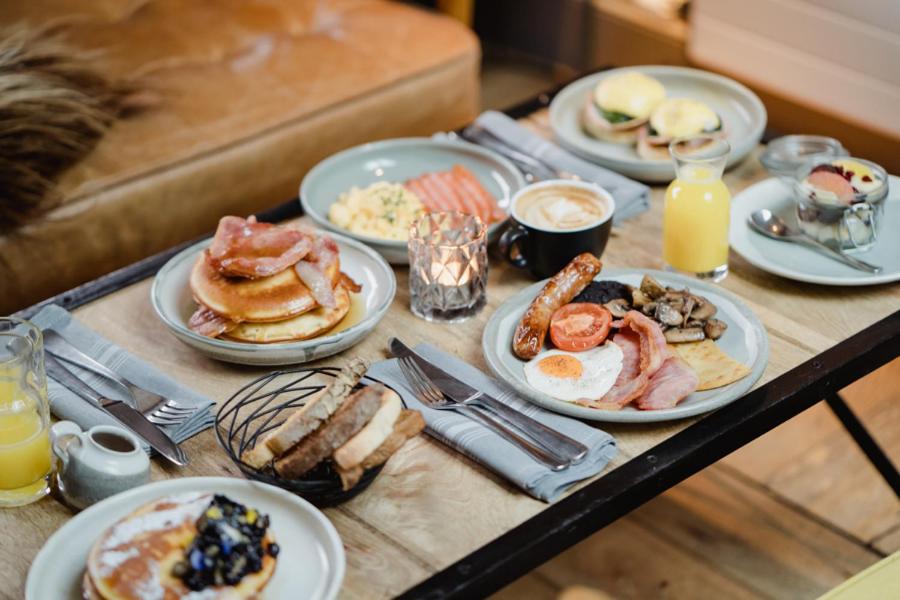 a table with plates of breakfast food on it at The Bonnie Badger in Gullane