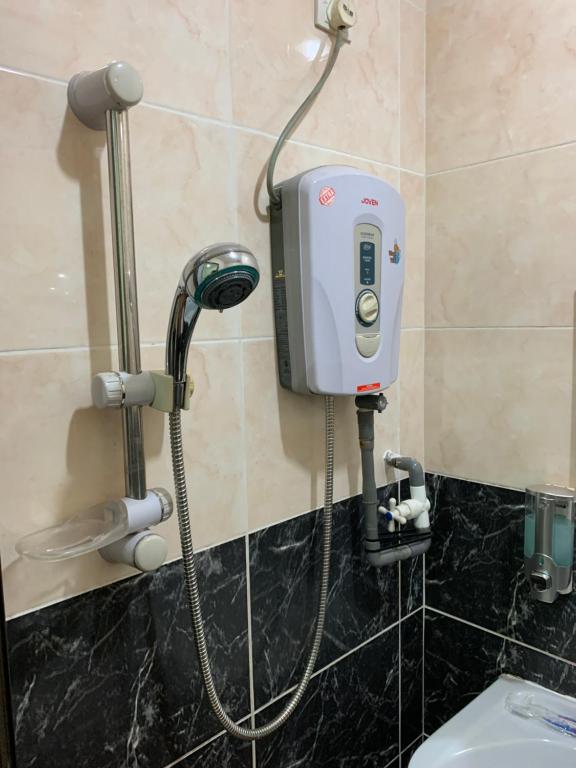 a soap dispenser on the wall of a bathroom at Hotel Bajet Pulai in Ipoh