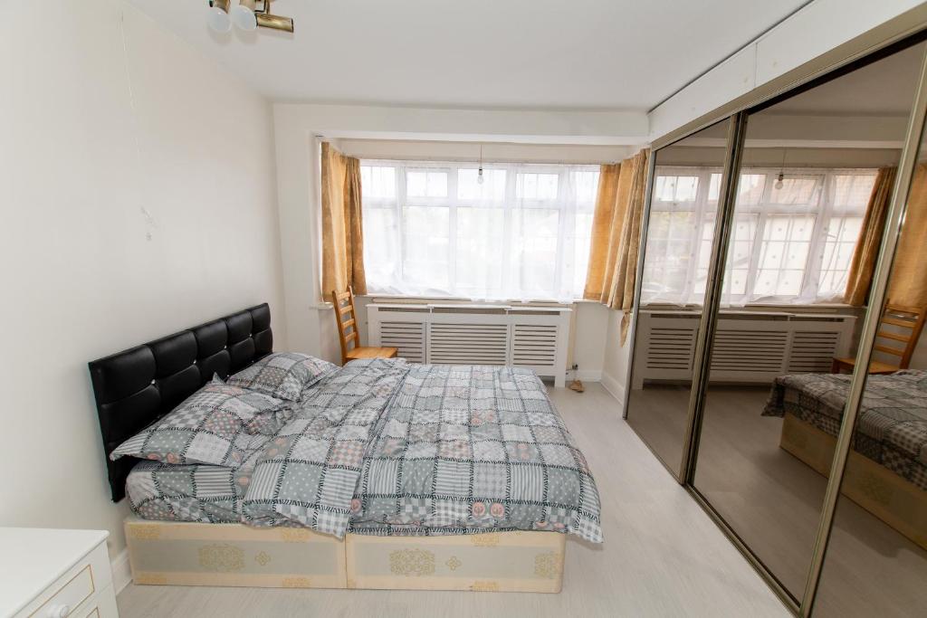 a bedroom with a bed and a mirror at OAK AVENUE HOME in Shirley