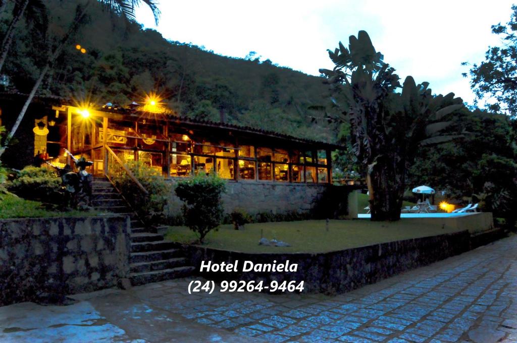 a hotel daranda is lit up at night at Hotel Daniela in Penedo
