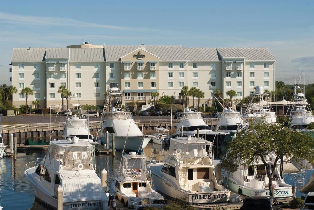 a group of boats docked in front of a building at SpringHill Suites by Marriott Charleston Riverview in Charleston