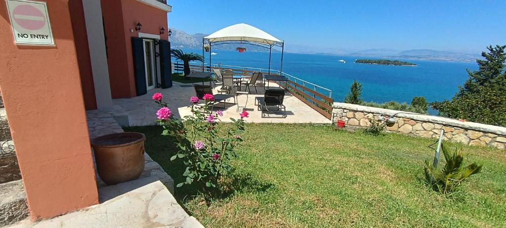 a house with a garden with a view of the water at Corfu town 'PANORAMIC VIEW HOUSE' in Alykes Potamou