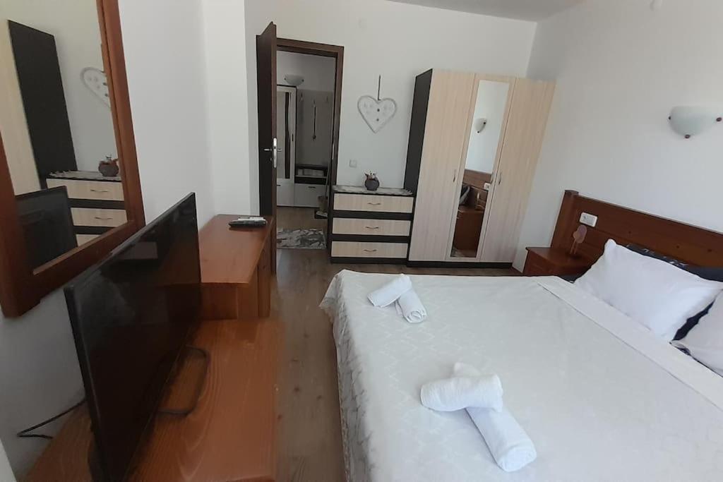 a bedroom with a bed with two towels on it at Diamond Heights apartament in Bansko