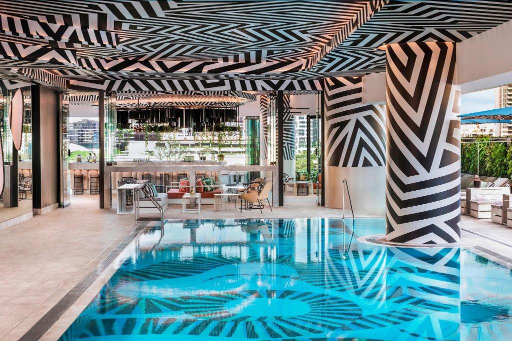 a swimming pool with a black and white patterned ceiling at W Brisbane in Brisbane