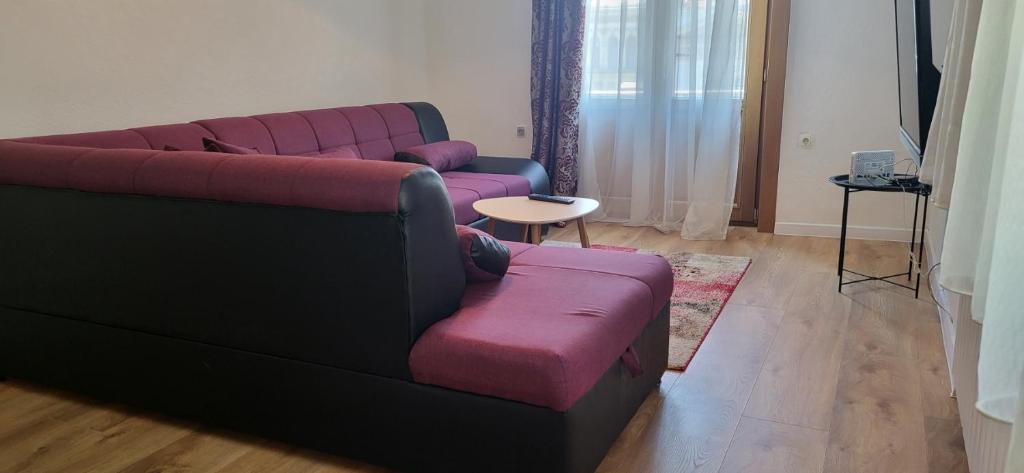 a living room with a purple couch and a pink chair at Amour Terrace in Sarajevo