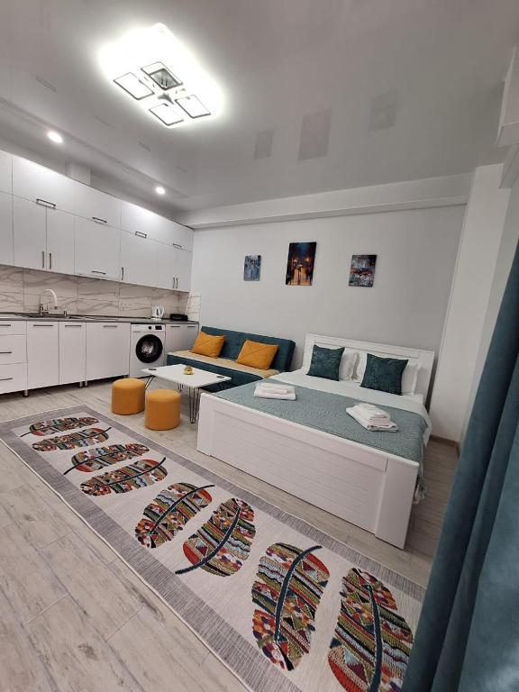 a large bedroom with two beds and a kitchen at kato's apartment in Tbilisi City