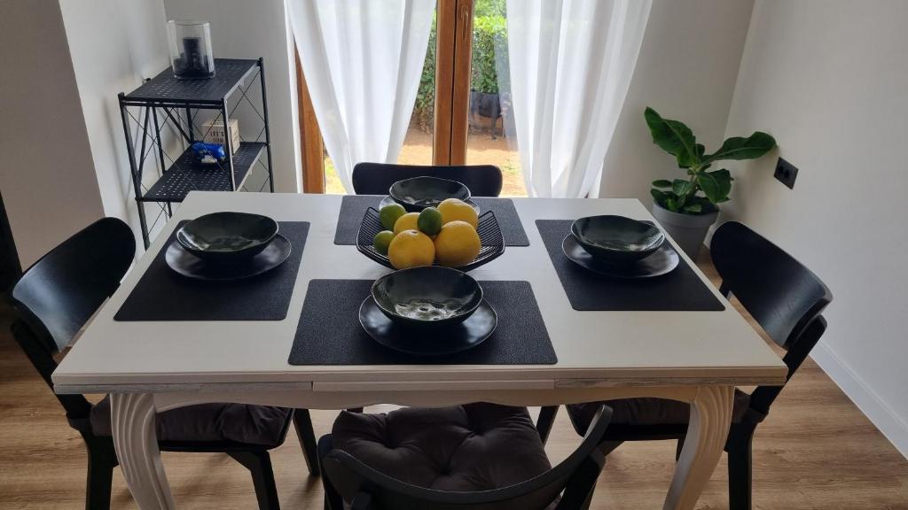 a dining room table with a bowl of fruit on it at Apartman Laura in Rijeka