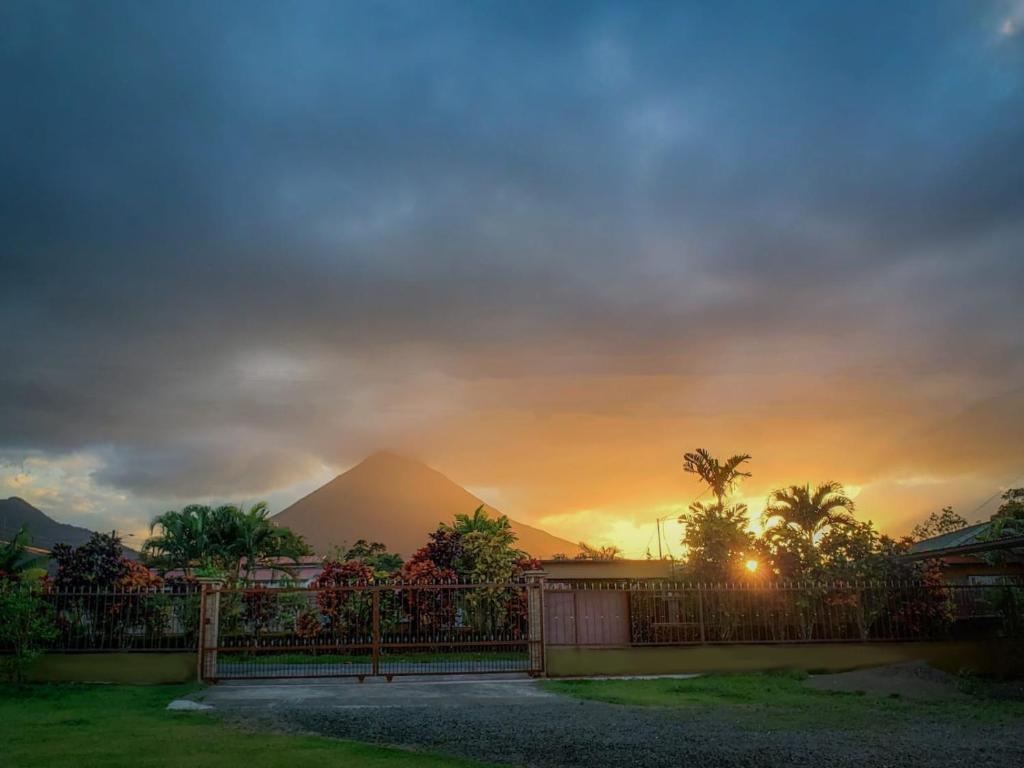 a view of a mountain at sunset with a fence at Volcano View Apartment in Fortuna