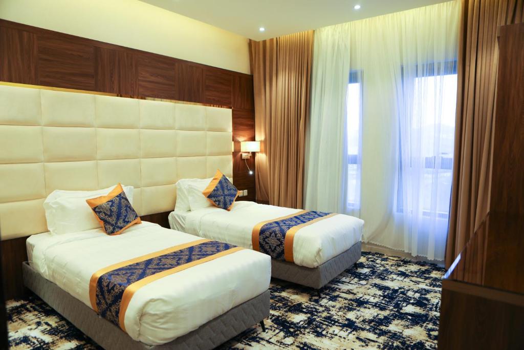 Postel nebo postele na pokoji v ubytování Oriens Hotel