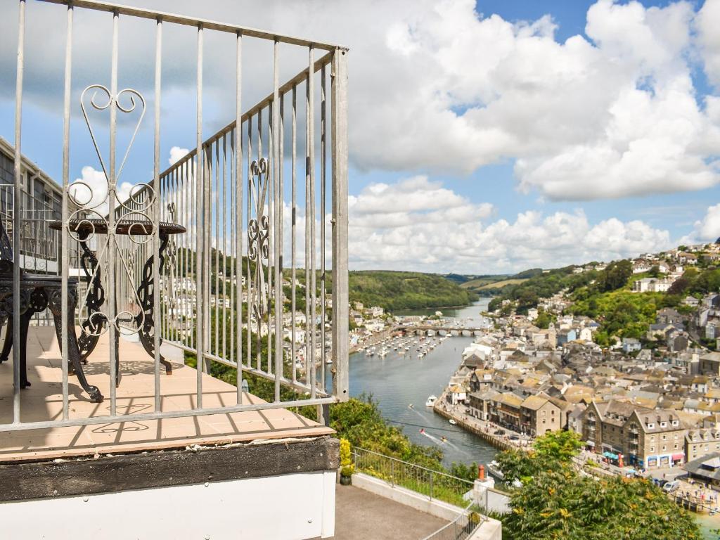 a balcony with a view of a river and a city at The Dawn in Looe