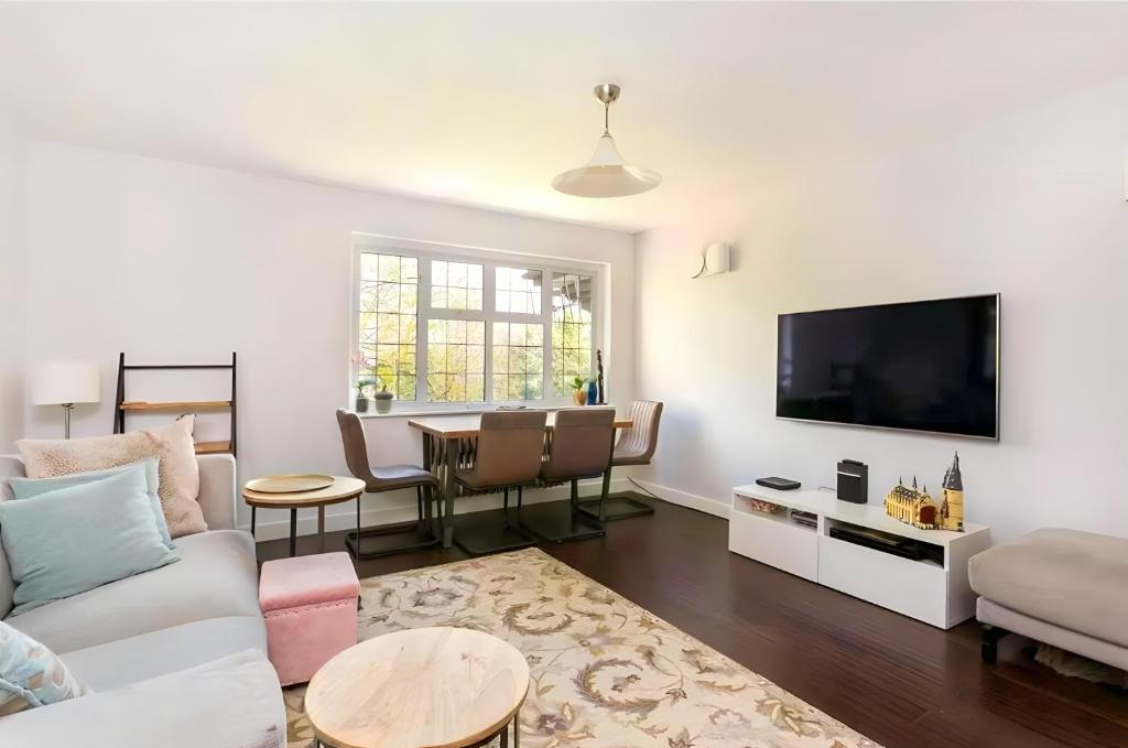a living room with a couch and a table at Exclusive Apartment in Greater London in Croxley Green