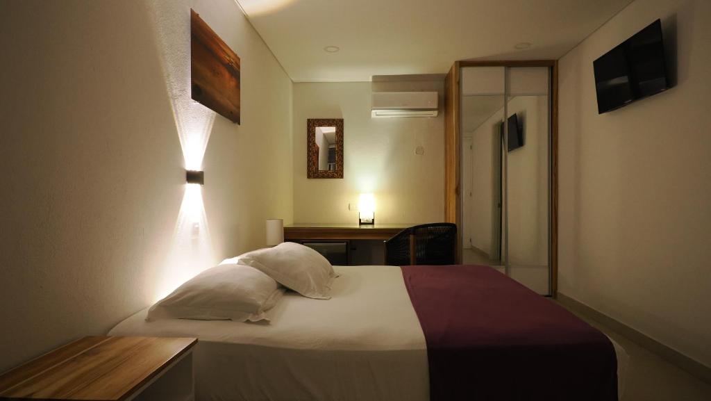 Postel nebo postele na pokoji v ubytování Hotel Casa Cytia