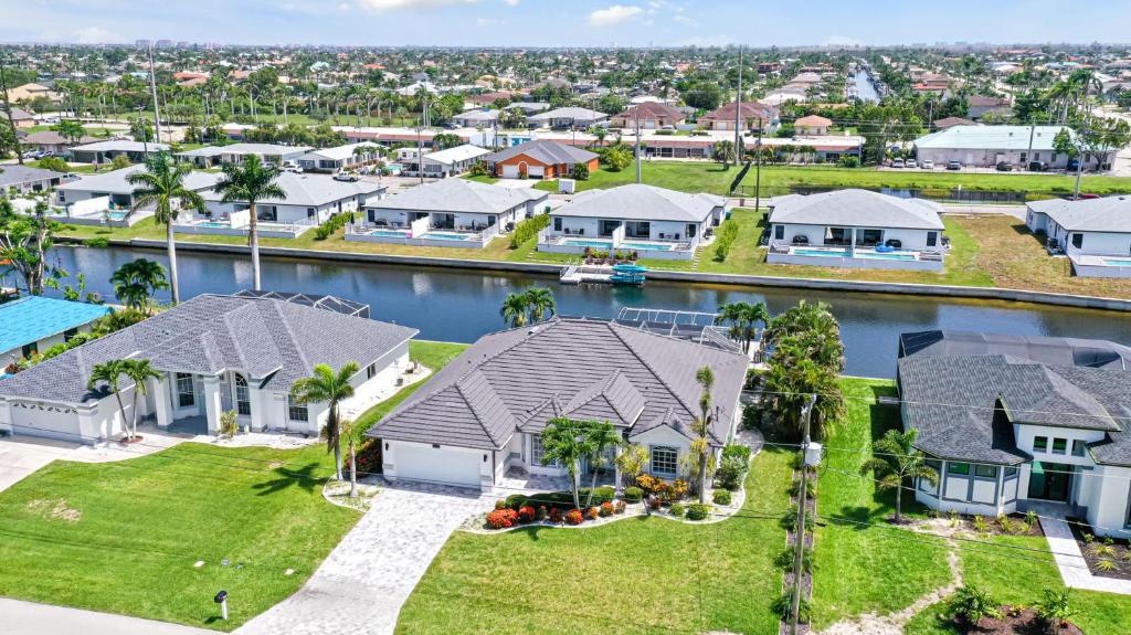an aerial view of a residential neighborhood with houses at Private Pool, Spacious Kitchen, Backed Up To Canal in Cape Coral