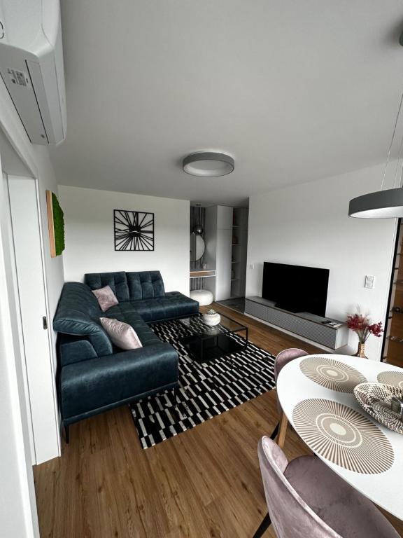 a living room with a couch and a table at APARTMAN LORINČIK KOSICE in Košice