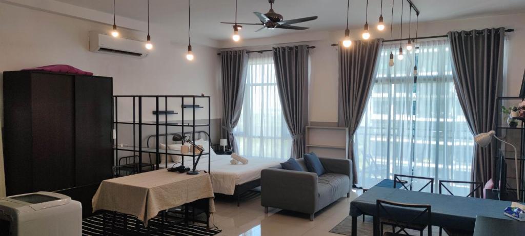 a living room with a bed and a dining room at MOLEK REGENCY TAMAN MOLEK in Johor Bahru