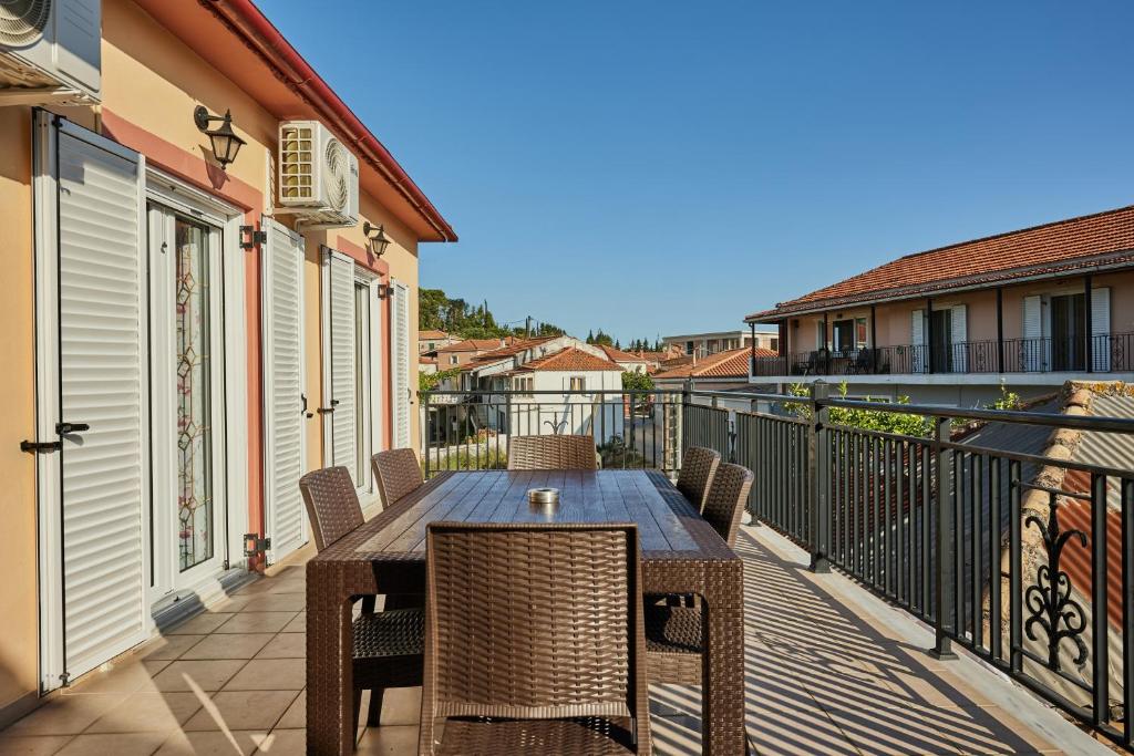 a patio with a table and chairs on a balcony at Villa Roxa Montuoso in Agios Leon