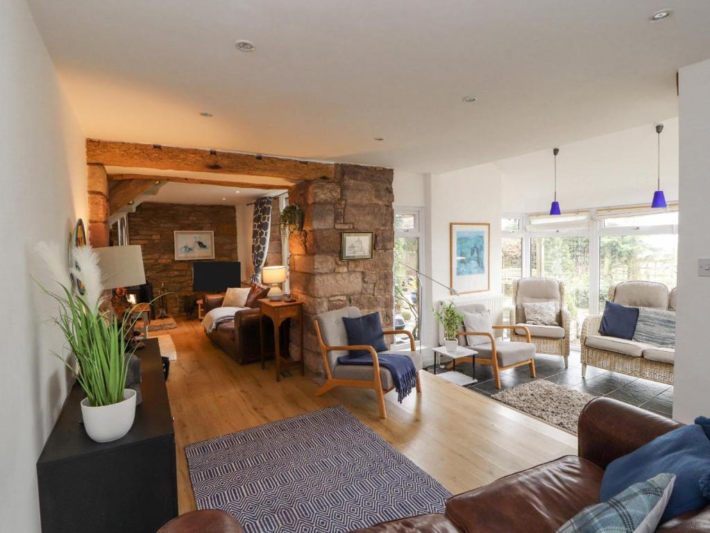 a living room with a stone wall at Barn End in Penrith