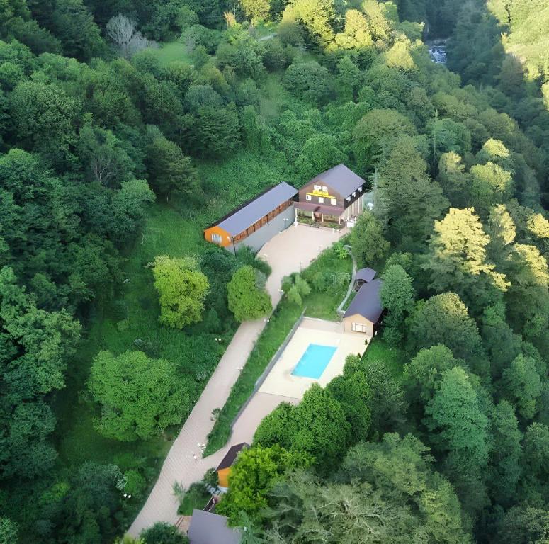 an aerial view of a house in the woods at Гостиница "Радоновый источник" in Tqvarchʼeli