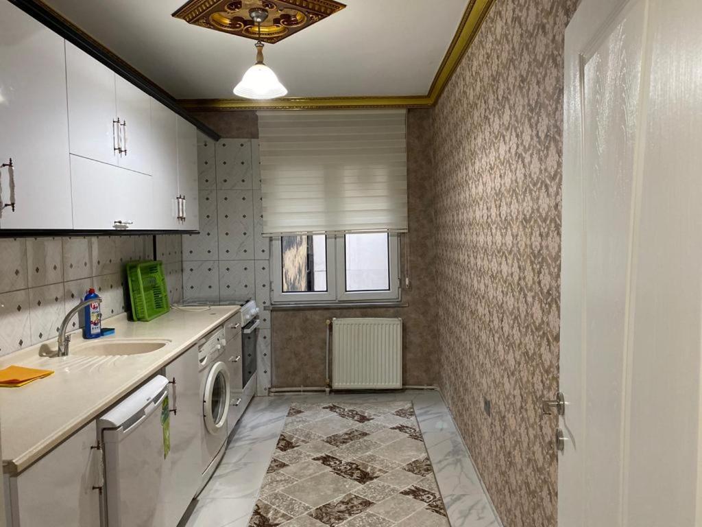 a kitchen with a washing machine and a sink at Demir Apart in Trabzon