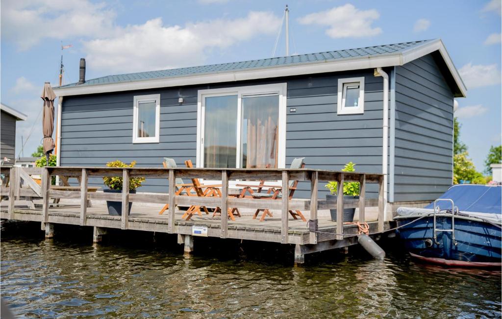 a tiny house on a dock on the water at Cozy Home In Breukelen With Wifi in Breukelen