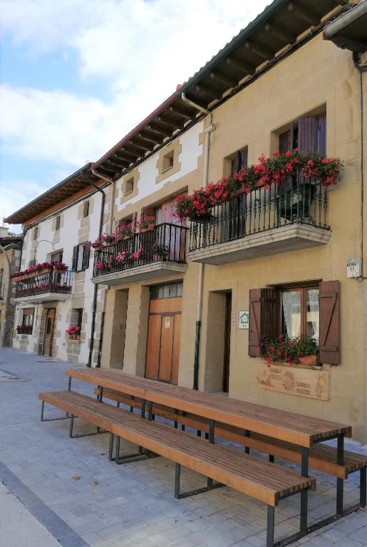 a row of benches in front of a building at Casa Rural Reparaz in Arbizu
